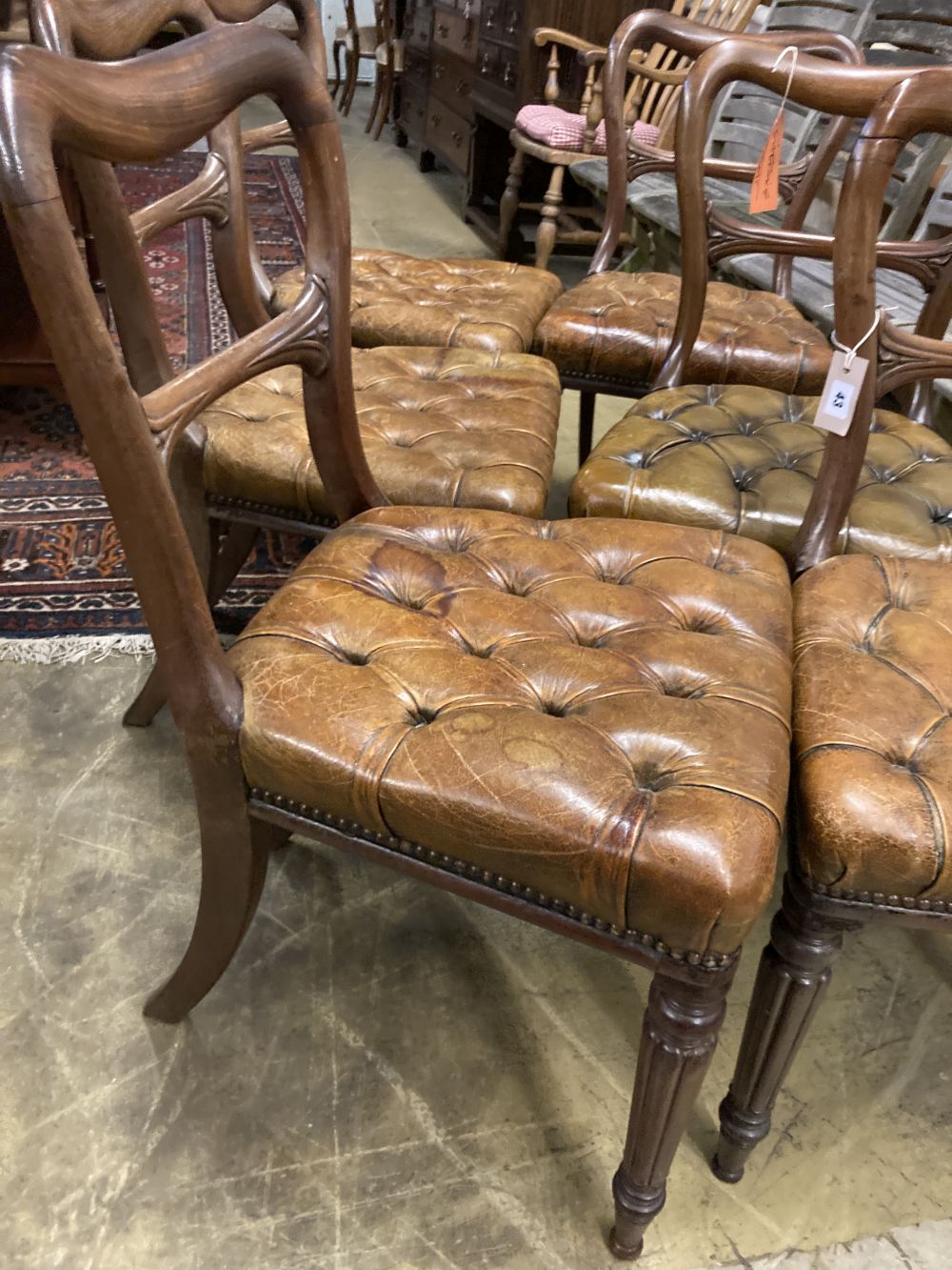 A set of six early Victorian mahogany dining chairs, with buttoned leather seats